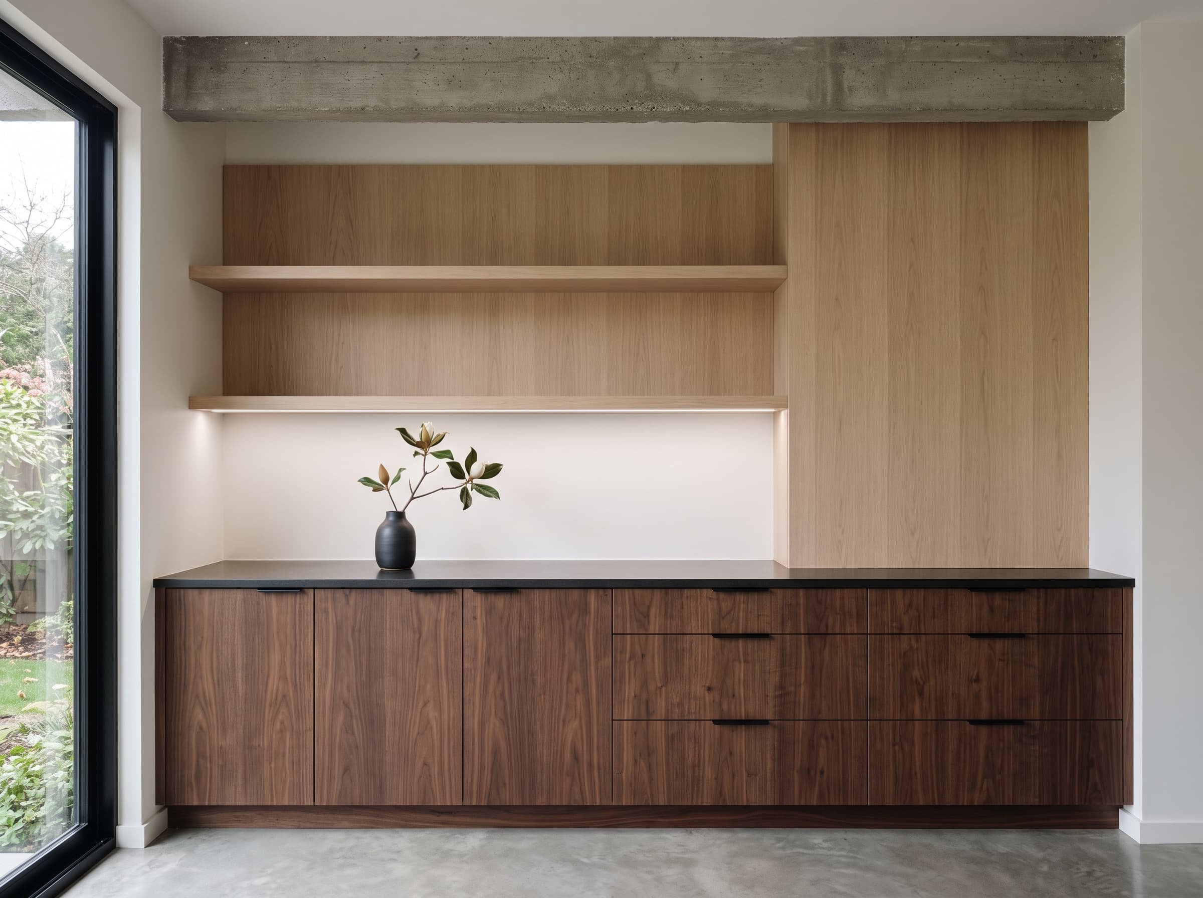 Custom European rift white oak kitchen cabinetry with Taj Mahal quartzite waterfall island